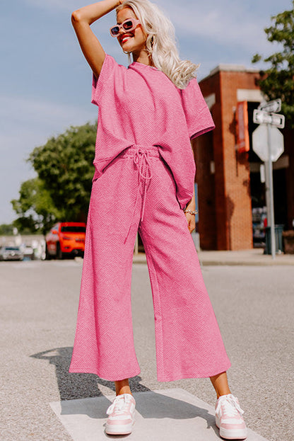 Conjunto de camiseta holgada con textura rosa fresa y pantalones con cordón