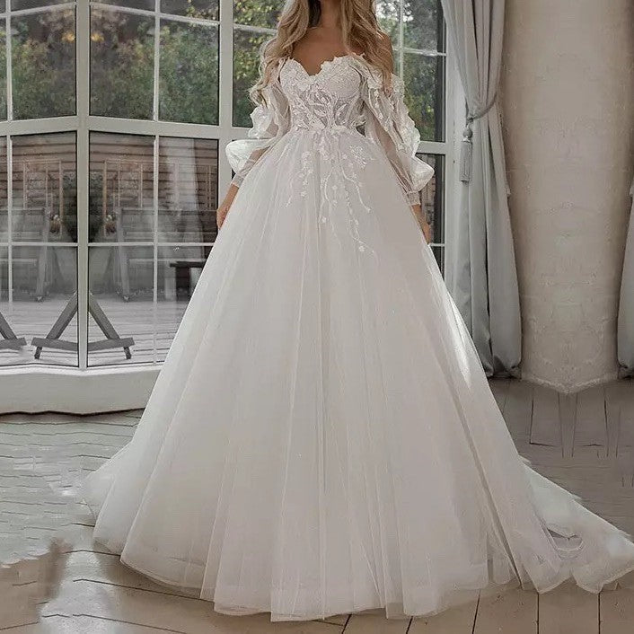 Vestido de novia bohemio con mangas abullonadas y hombros descubiertos