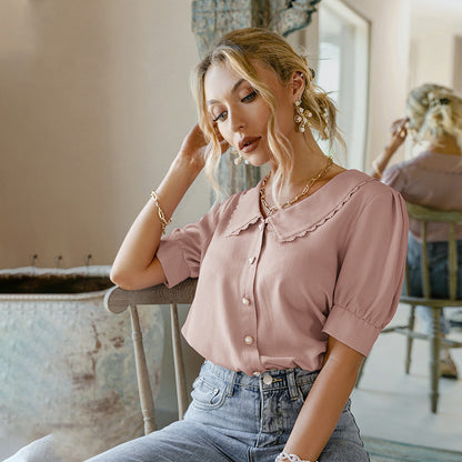 Blusa con cuello de muñeca y mangas abullonadas