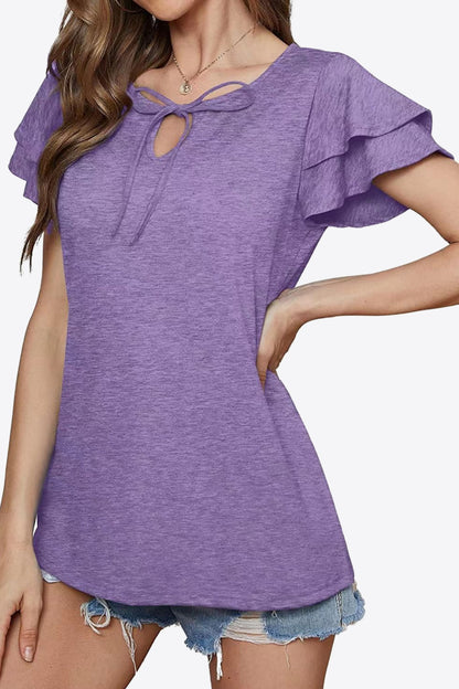 Blusa con mangas acampanadas y capas con cuello anudado