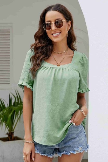 Blusa con cuello cuadrado y manga abullonada con ribete de volantes