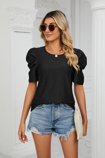 Blouse à col rond et manches bouffantes à œillets