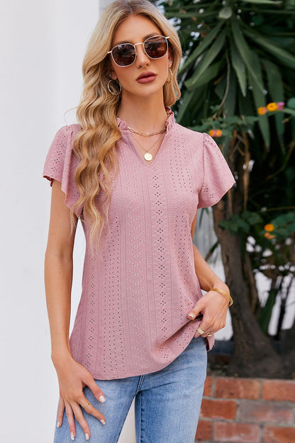 Blusa con mangas abullonadas y cuello con muescas