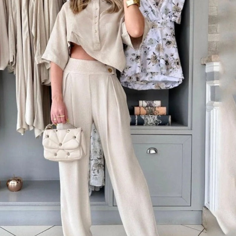 Traje de pantalón casual con top irregular y sentido del diseño de moda de color sólido