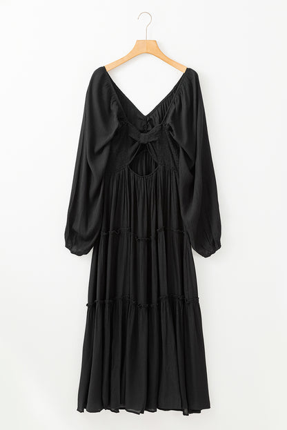 Robe longue noire à volants et découpes avec nœud papillon et col en V