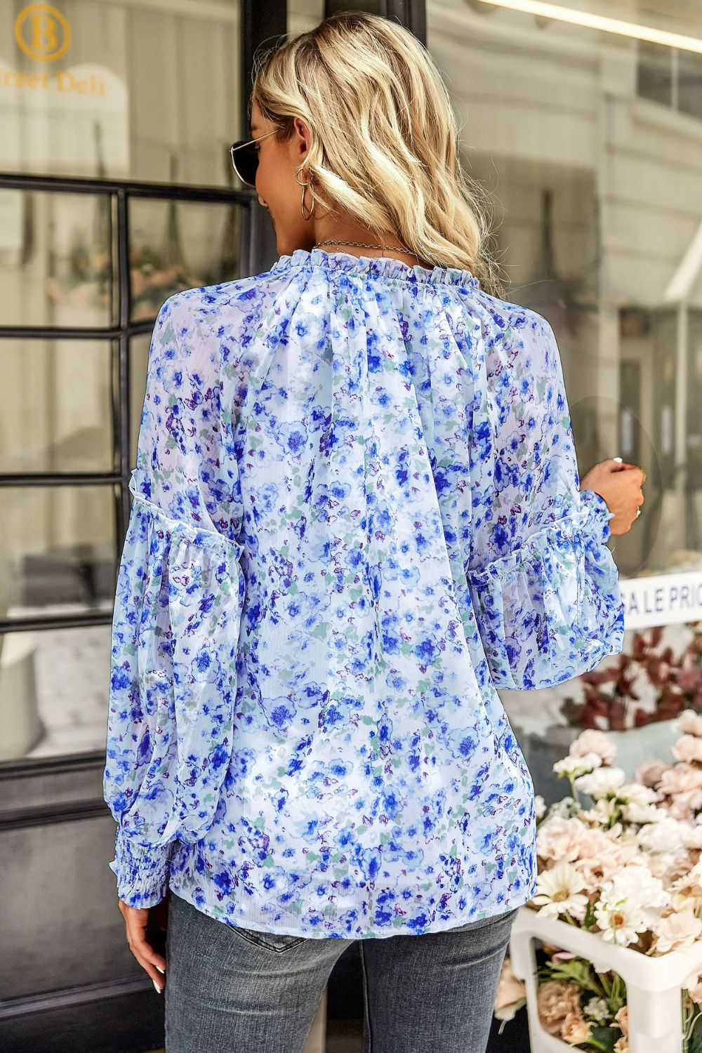 Blouse florale à manches lanternes et col noué