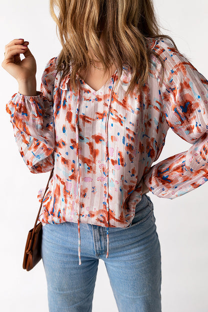 Blusa estampada con mangas globo y volantes