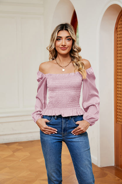 Blouse smockée à épaules dénudées et ourlet à volants