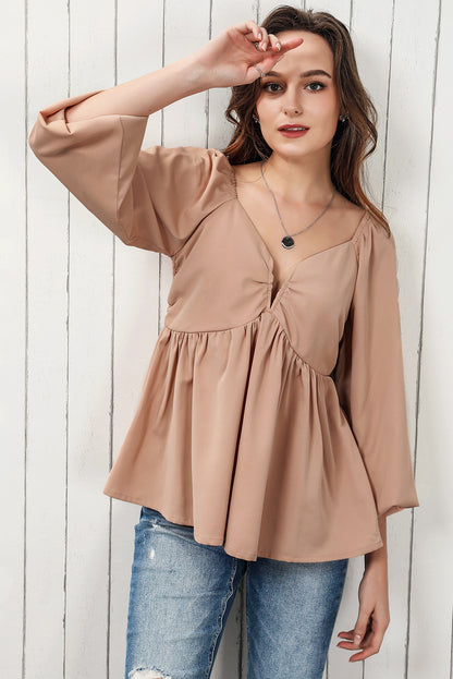 Blouse babydoll smockée à manches longues et nouée au dos