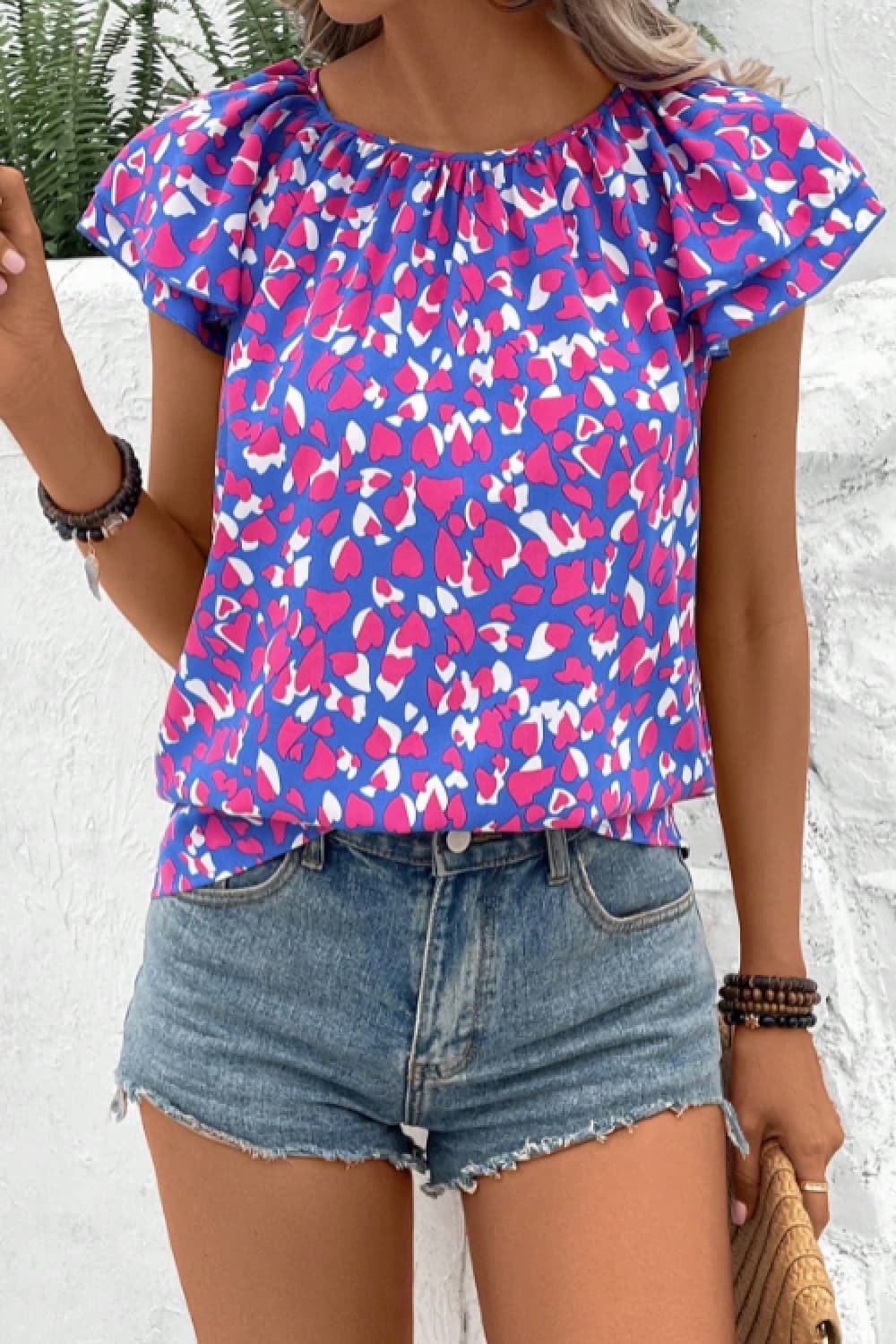 Blusa estampada con cuello redondo y mangas acampanadas